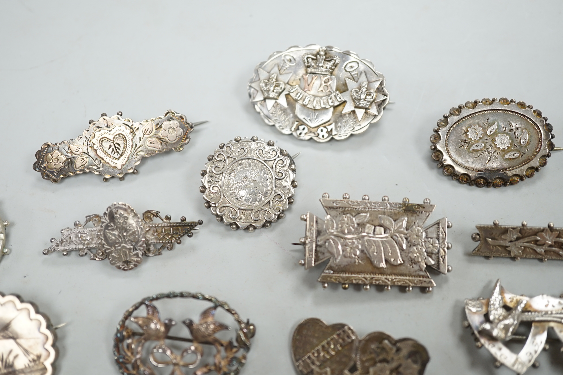 A small collection of twenty nine assorted Victorian and later silver or white metal brooches.